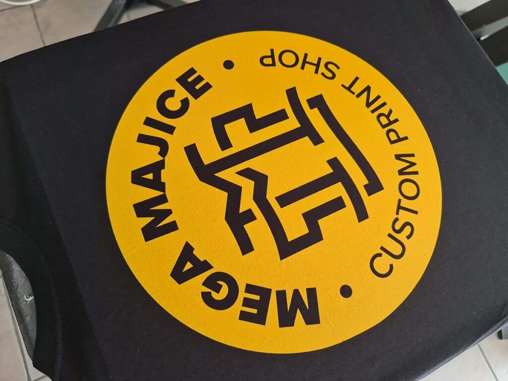 Yellow screen print in two passes on black t-shirts